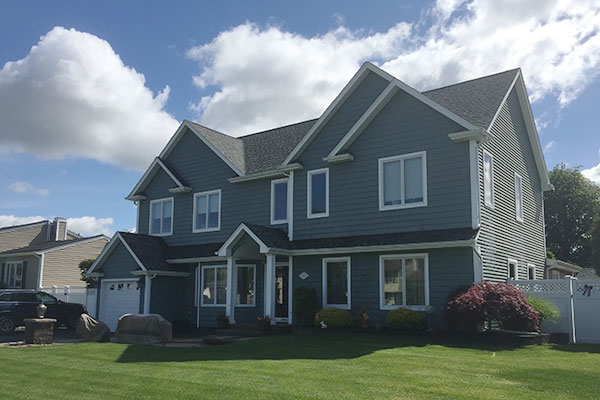 Joe showing clean windows on a house after cleaning.